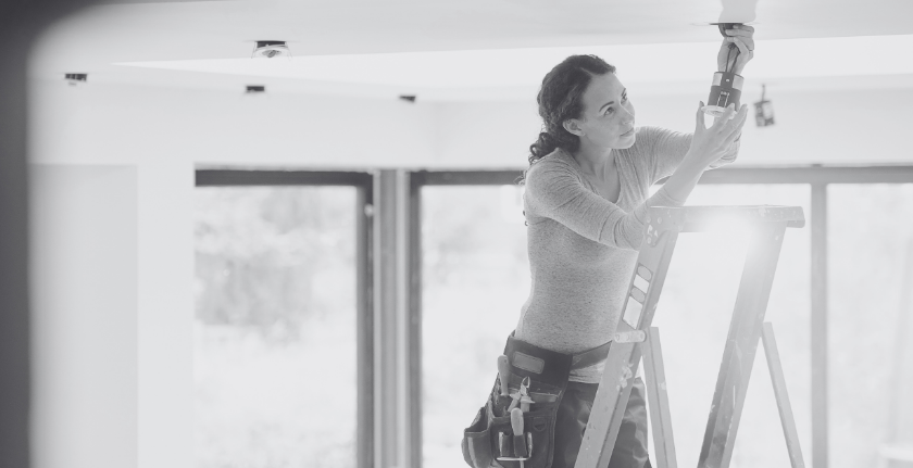 Electrician installing light fittings home renovation