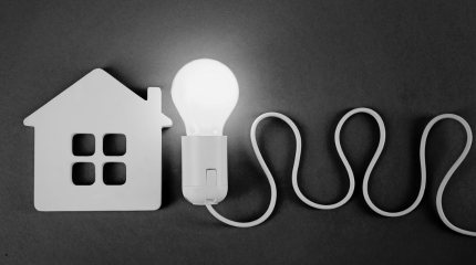 A grapihic image of a house and a lightbulb, suggests energy and positive thinking