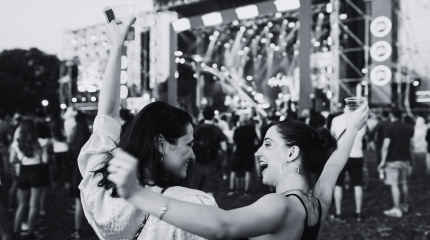 two friends at a festival enjoying music