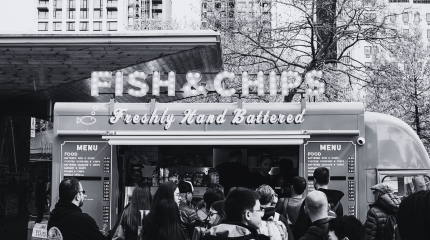 Fish and Chip van on a busy day serving lots of customers