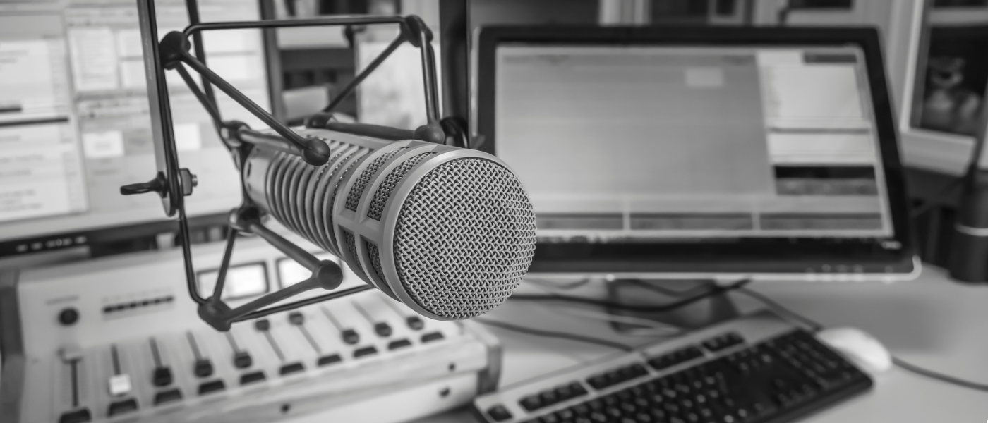 A picture of the microphone and desk at a radio station