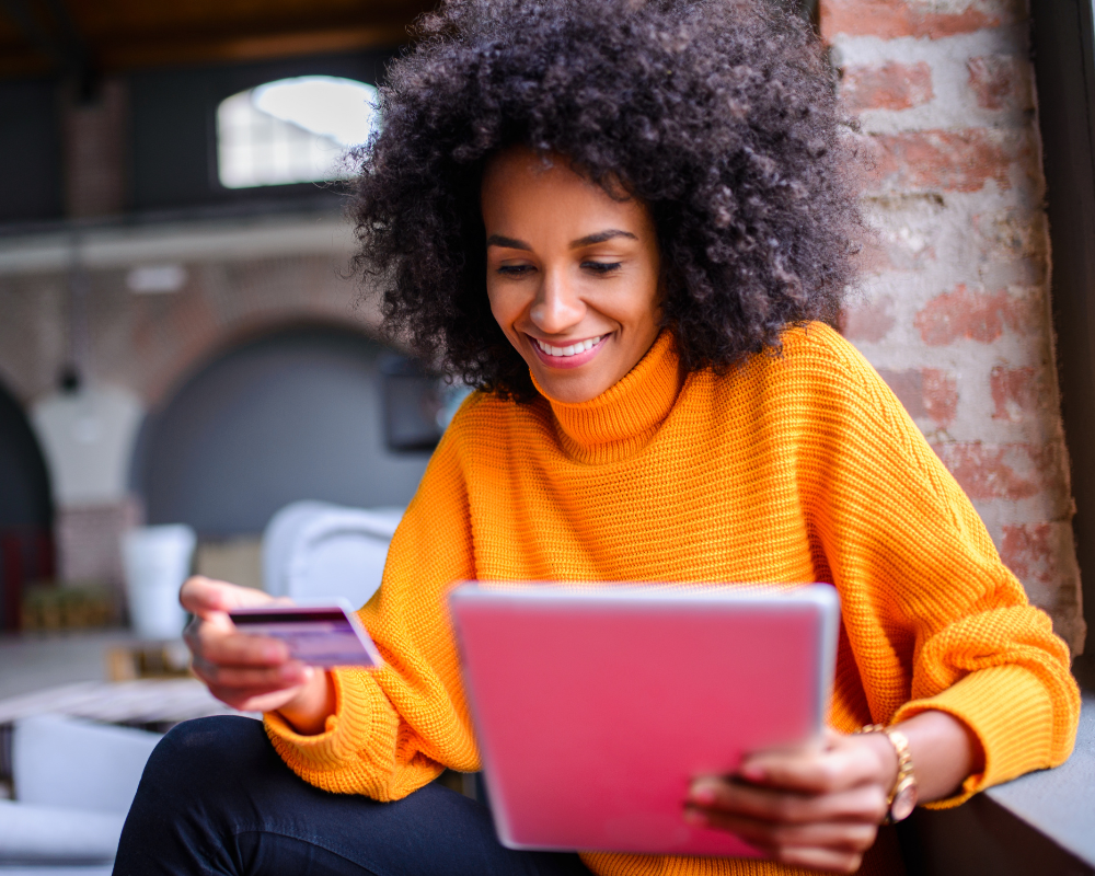 Customer is online shopping and using her credit card to make a purchase. 